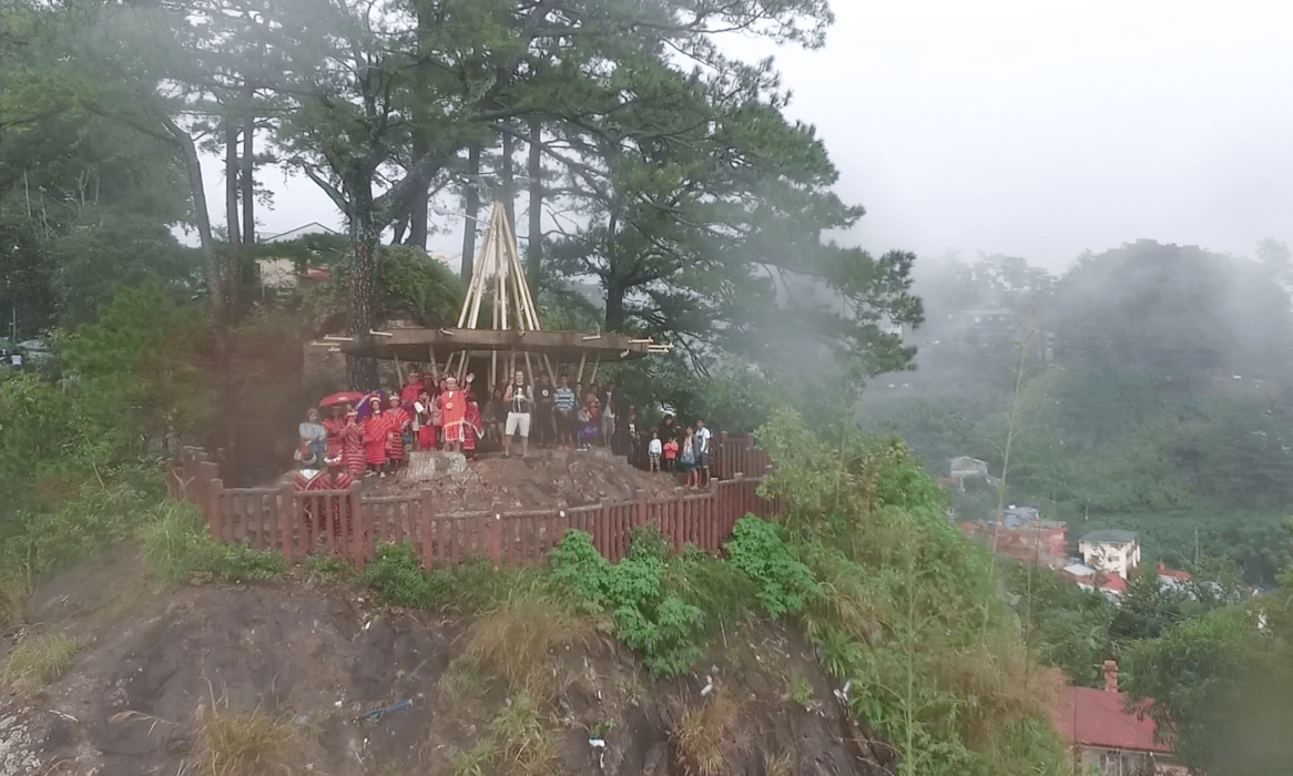 filipinos waving at Mines View Park observation deck looking over amburayan valley in baguio city philippines